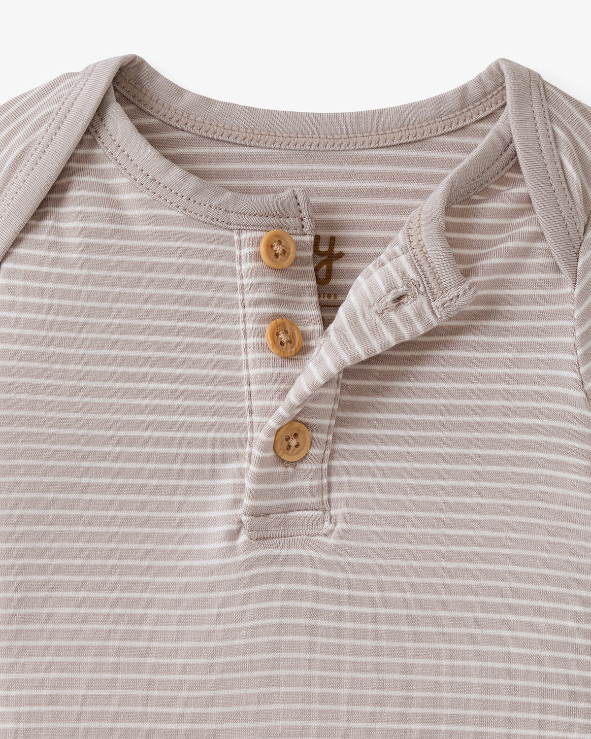 Close up flat lay of the button details on the Dove Gray Stripe Henley Bodysuit