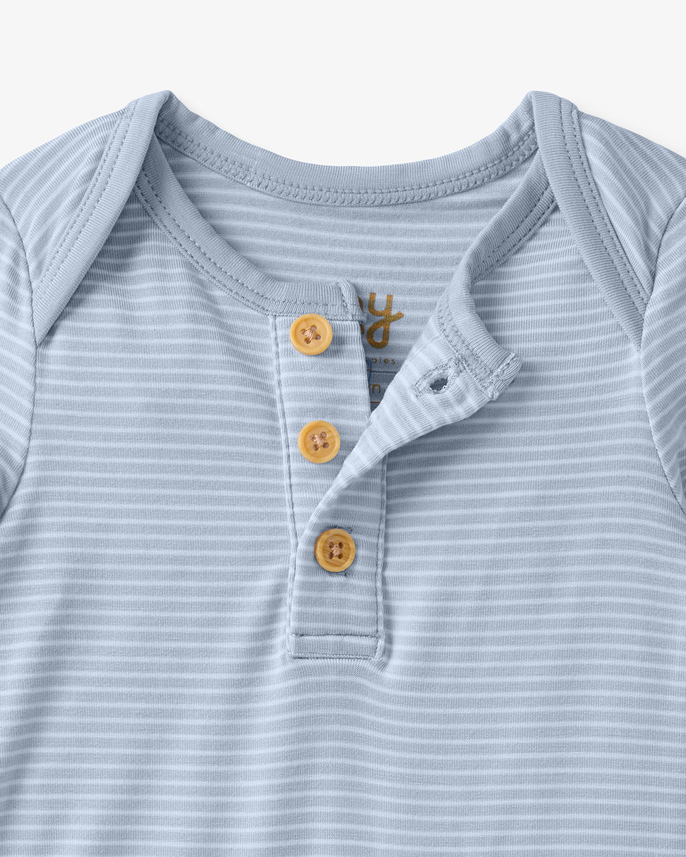 Close up flat lay of the button detail on the Light Fog Stripe Henley Bodysuit