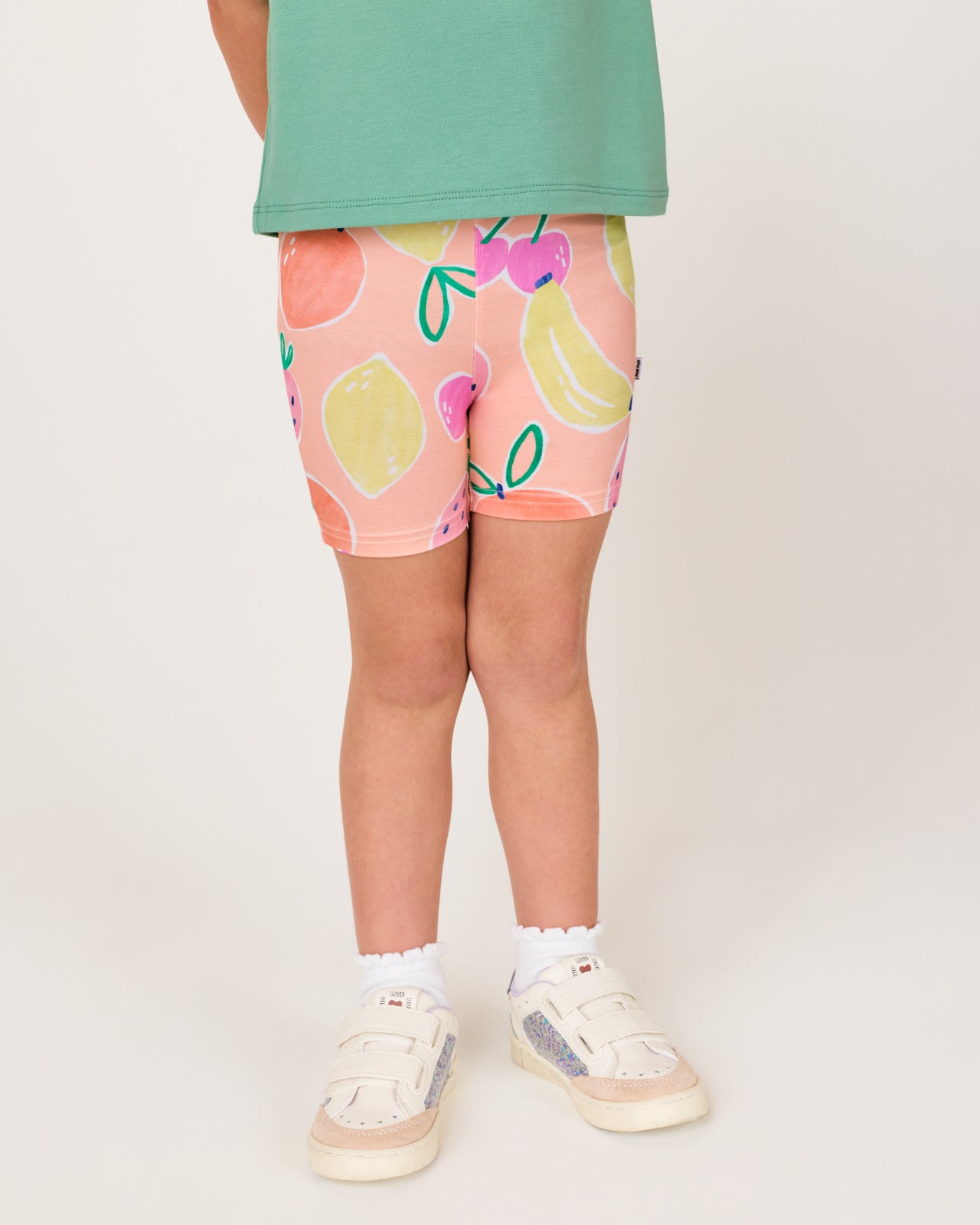 Close up of girl wearing the Fruit Frenzy Bike Shorts