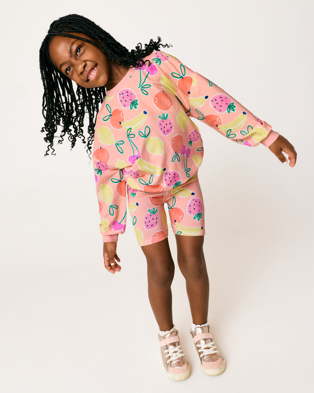 Girl wearing the Fruit Frenzy Bike Shorts and Crewneck