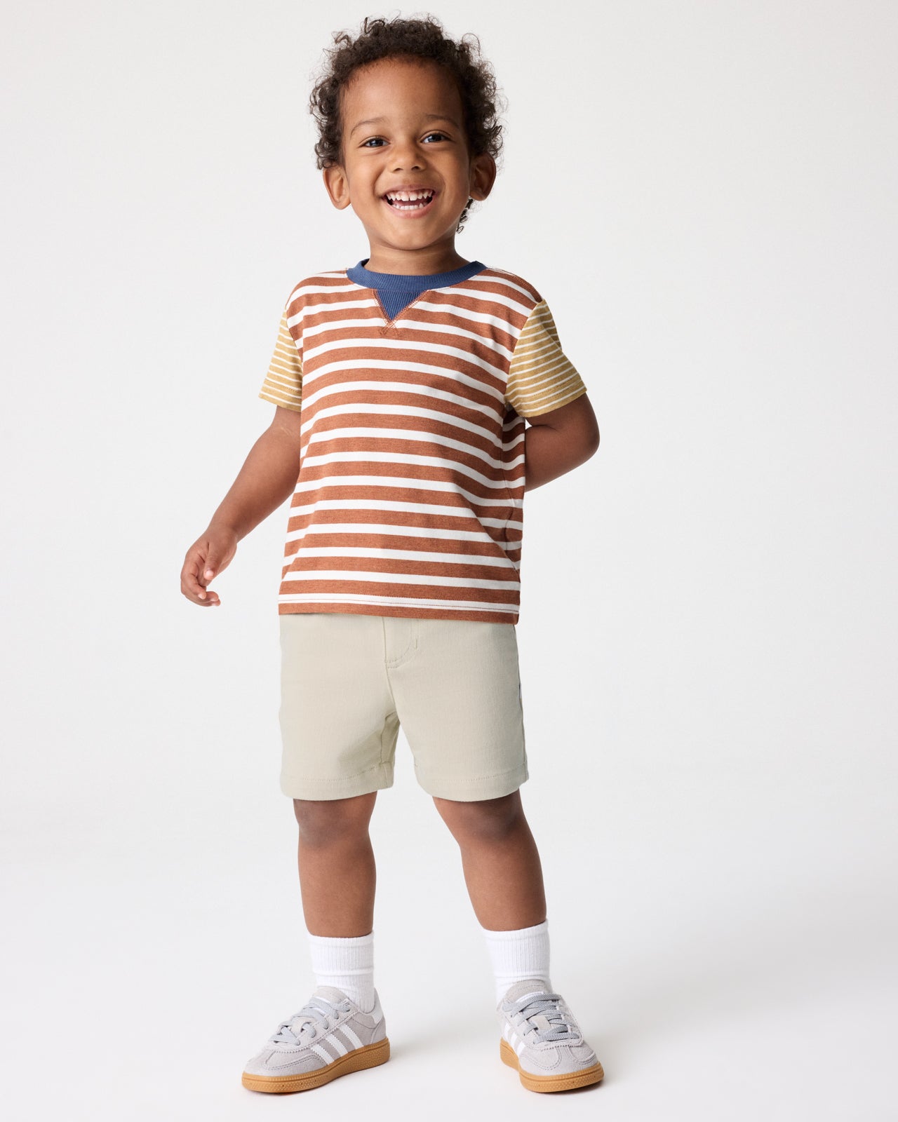 Boy wearing the Golden Amber Heather Stripe Relaxed Tee with khaki shorts