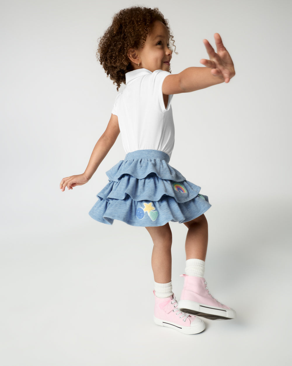 Child in motion wearing the Smiley Face Tiered Skort 