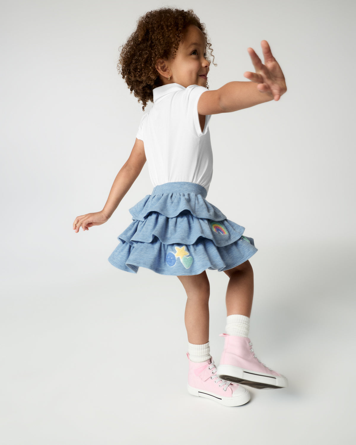 Child in motion wearing the Smiley Face Tiered Skort 