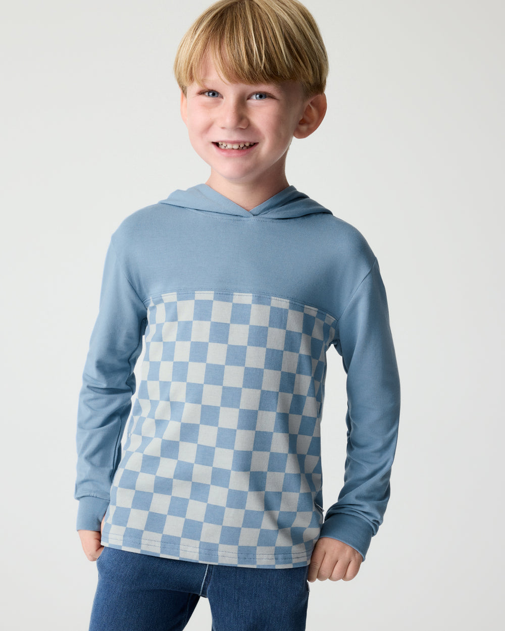 Boy wearing the Dusk Blue Checks Relaxed Hooded Tee with denim pants