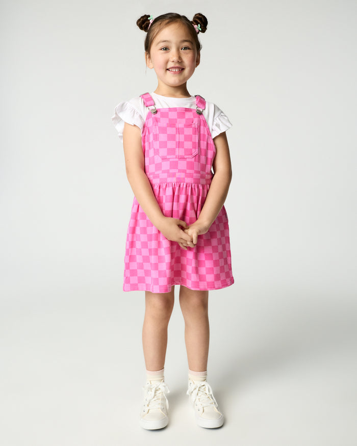 Girl wearing the Sweet Raspberry Checks Skirt Overall with a white flutter tee