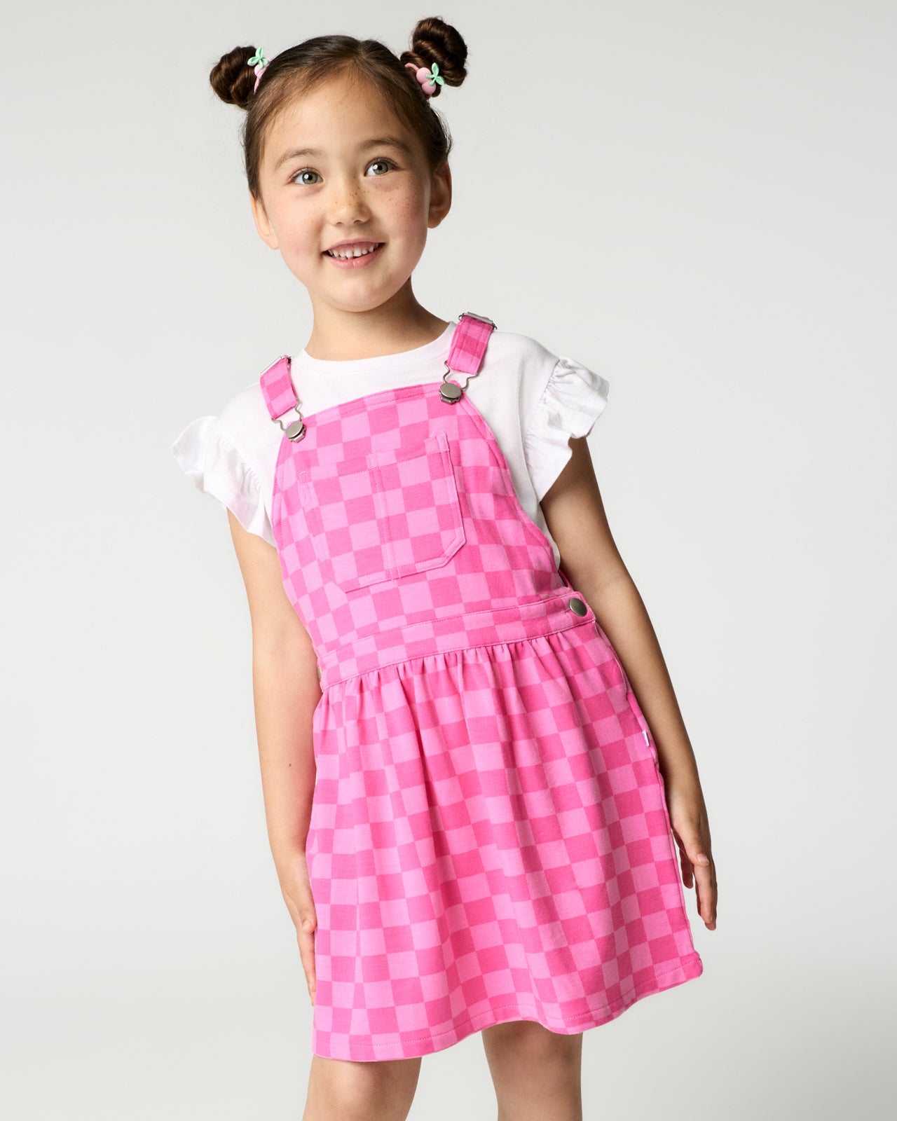 Close up of girl wearing the Sweet Raspberry Checks Skirt Overall over a white tee