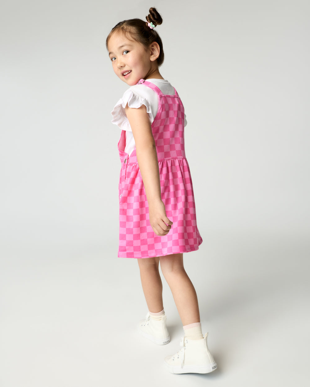 Back view of girl wearing the Sweet Raspberry Checks Skirt Overall