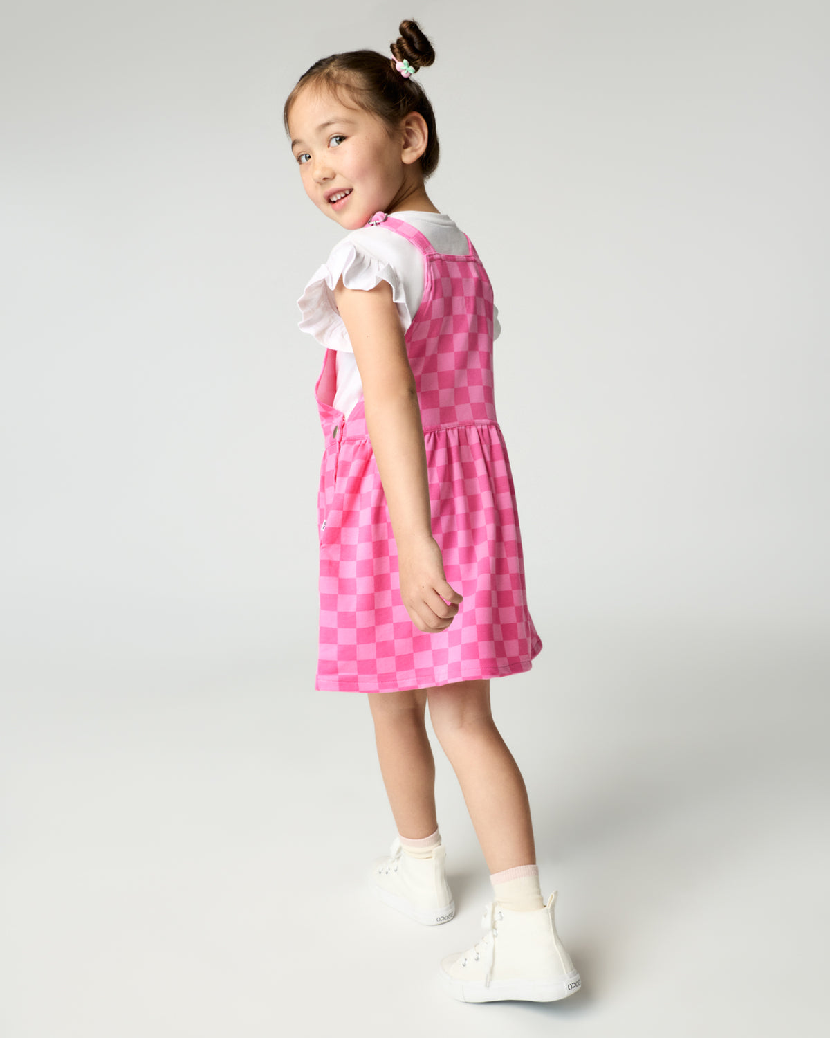Back view of girl wearing the Sweet Raspberry Checks Skirt Overall