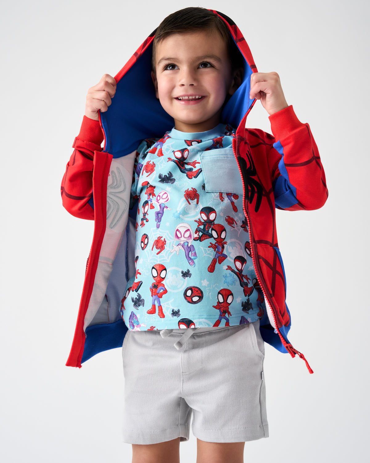 Boy wearing the Spidey Zip Hoodie layered over a Spidey & Friends Tiny Webs Relaxed Pocket Tee