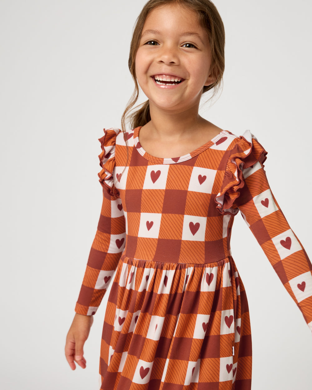 Close up of girl wearing the Harvest Hearts Flutter Skater Dress