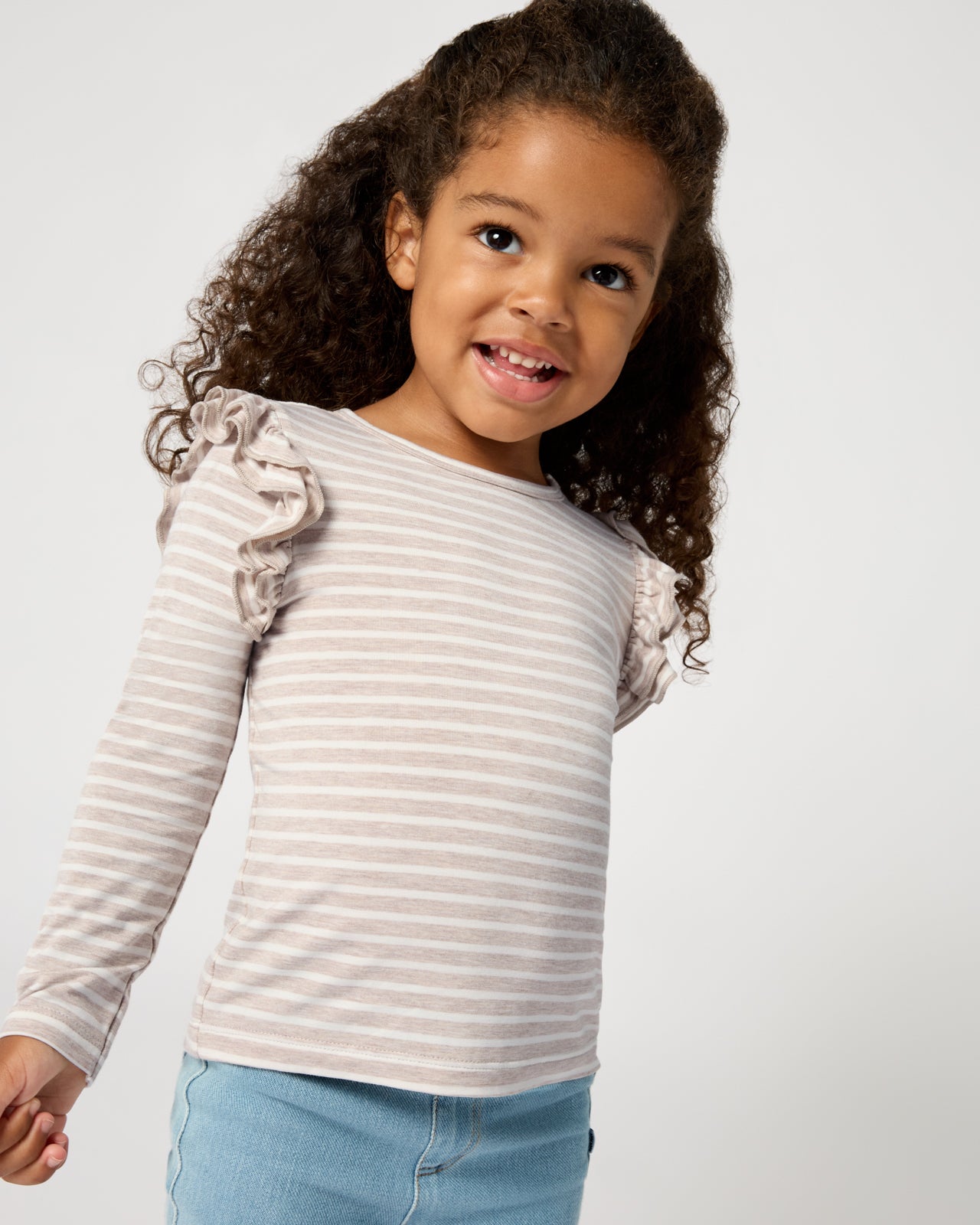 Close up of girl wearing the Linen Heather Stripe Flutter Tee