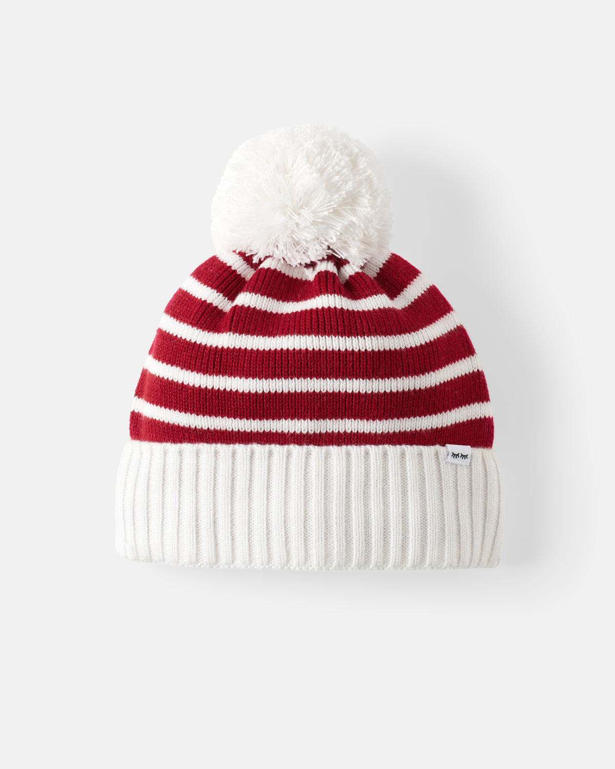 A red and white striped knit beanie with a fluffy white pom-pom on top and a ribbed white cuff, shown against a light gray background.