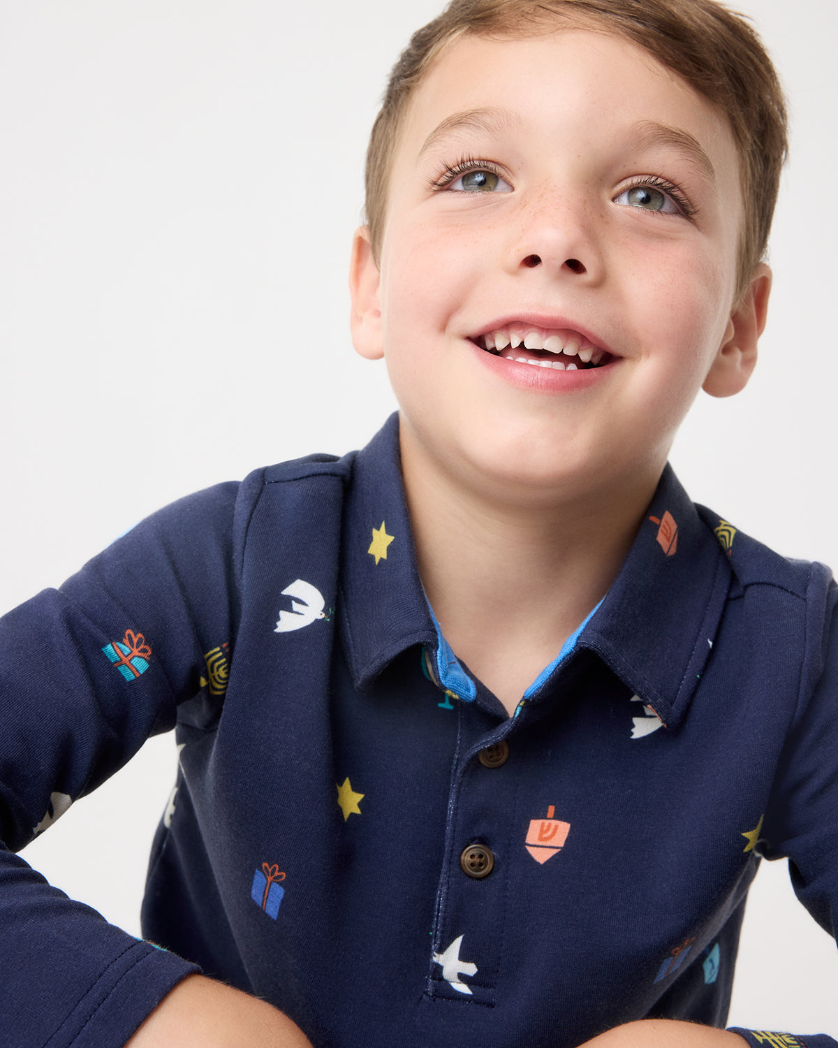 Close up of boy wearing the Hanukkah Wishes Polo Shirt