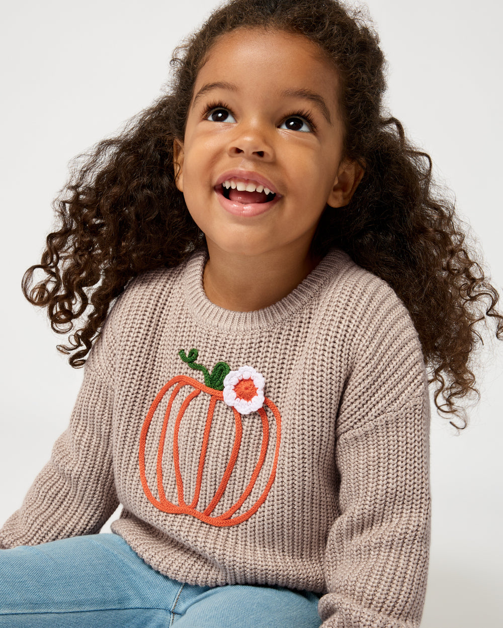 Close up of girl wearing the Pumpkin Drop Shoulder Sweater