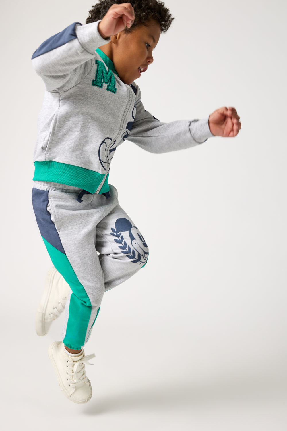 Child in motion wearing the Disney Mickey Mouse Sports Club Panel Jogger