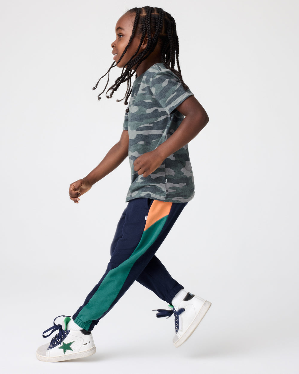 Child wearing the Classic Navy Panel Jogger with a came tshirt