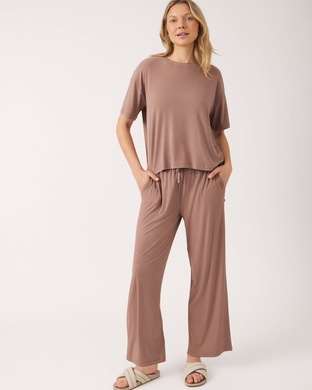 Standing woman wearing the Hazy Brown Women's Ribbed Boxy Tee and Pants with slides