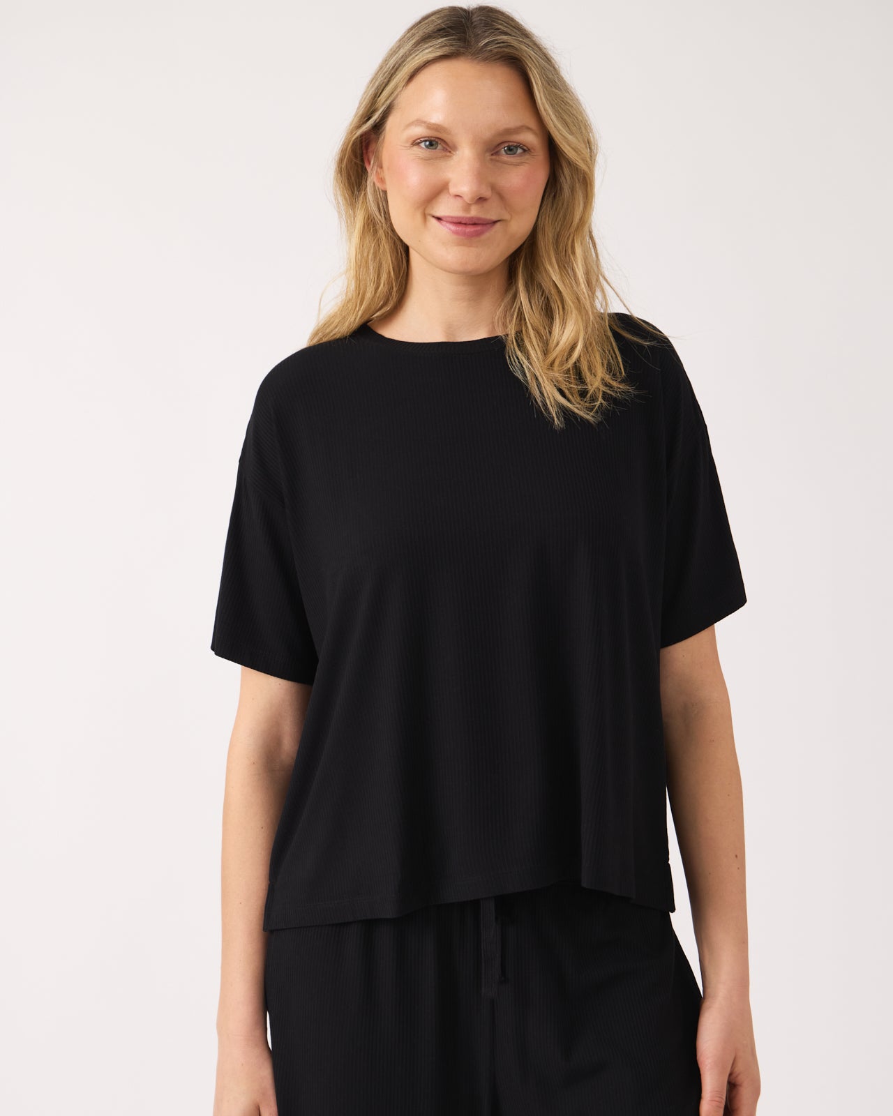 Woman wearing the Black Women's Ribbed Boxy Tee