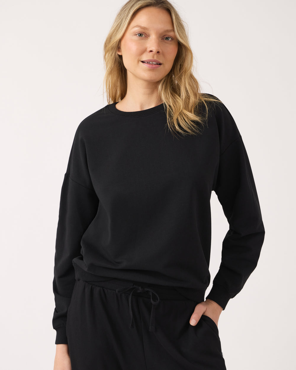 Woman wearing the Black Women's Everyday Crewneck Sweatshirt