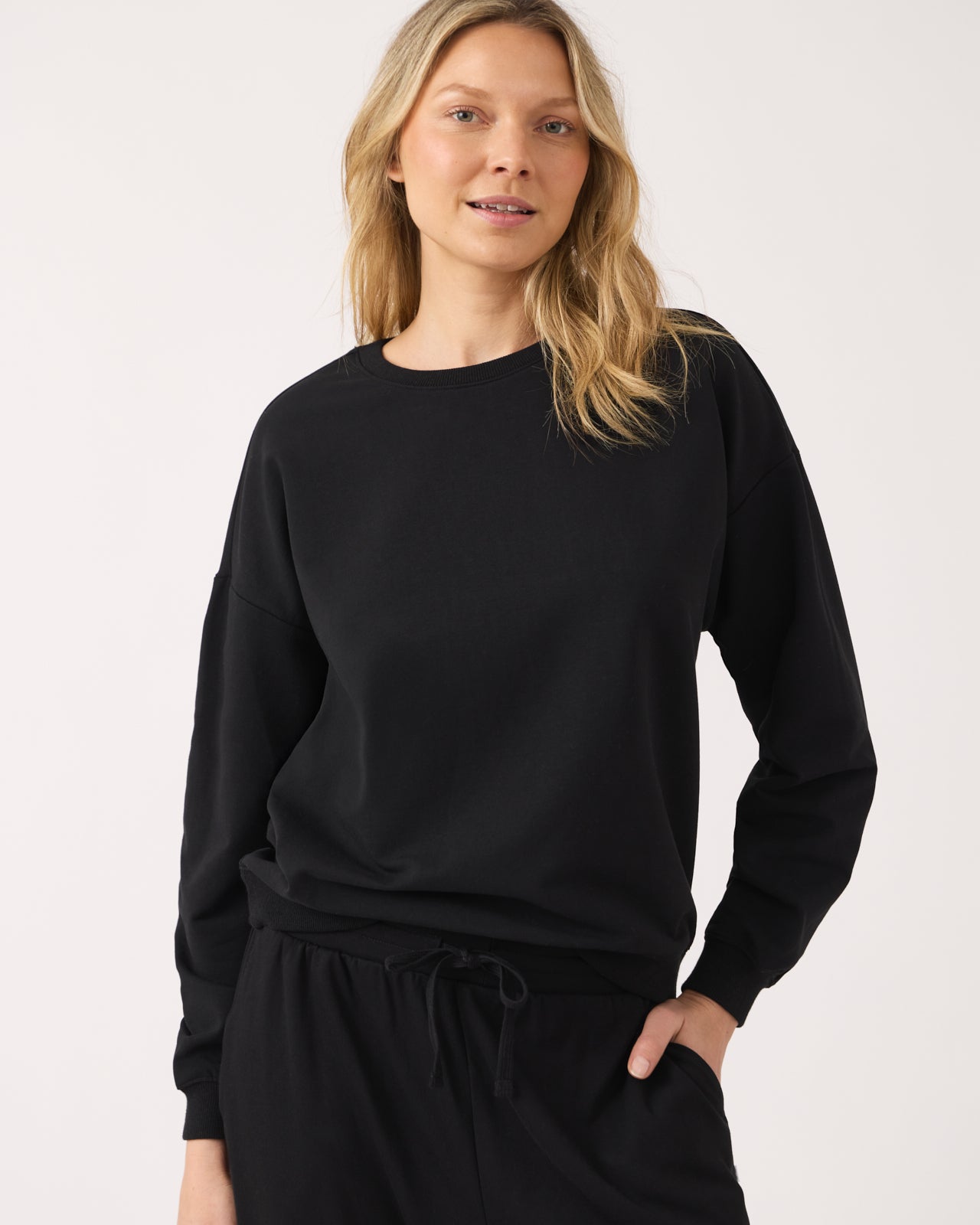 Woman wearing the Black Women's Everyday Crewneck Sweatshirt