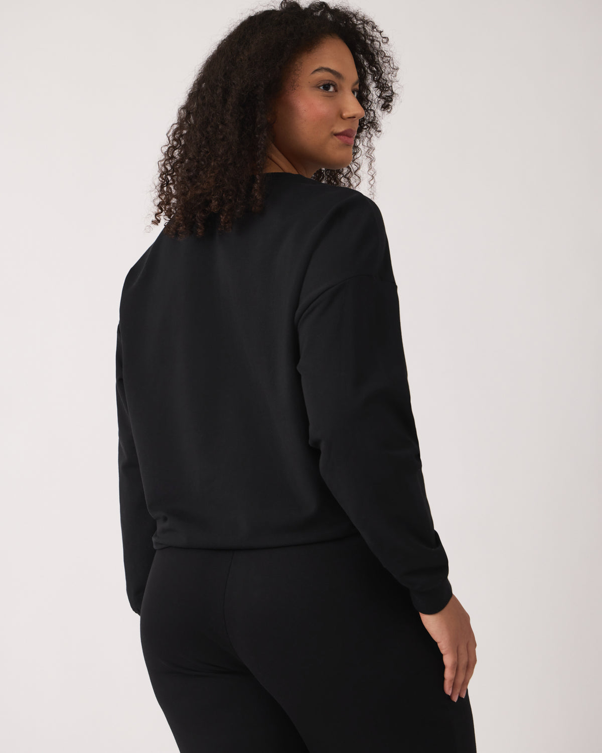 Back view of woman wearing the Black Women's Everyday Crewneck Sweatshirt