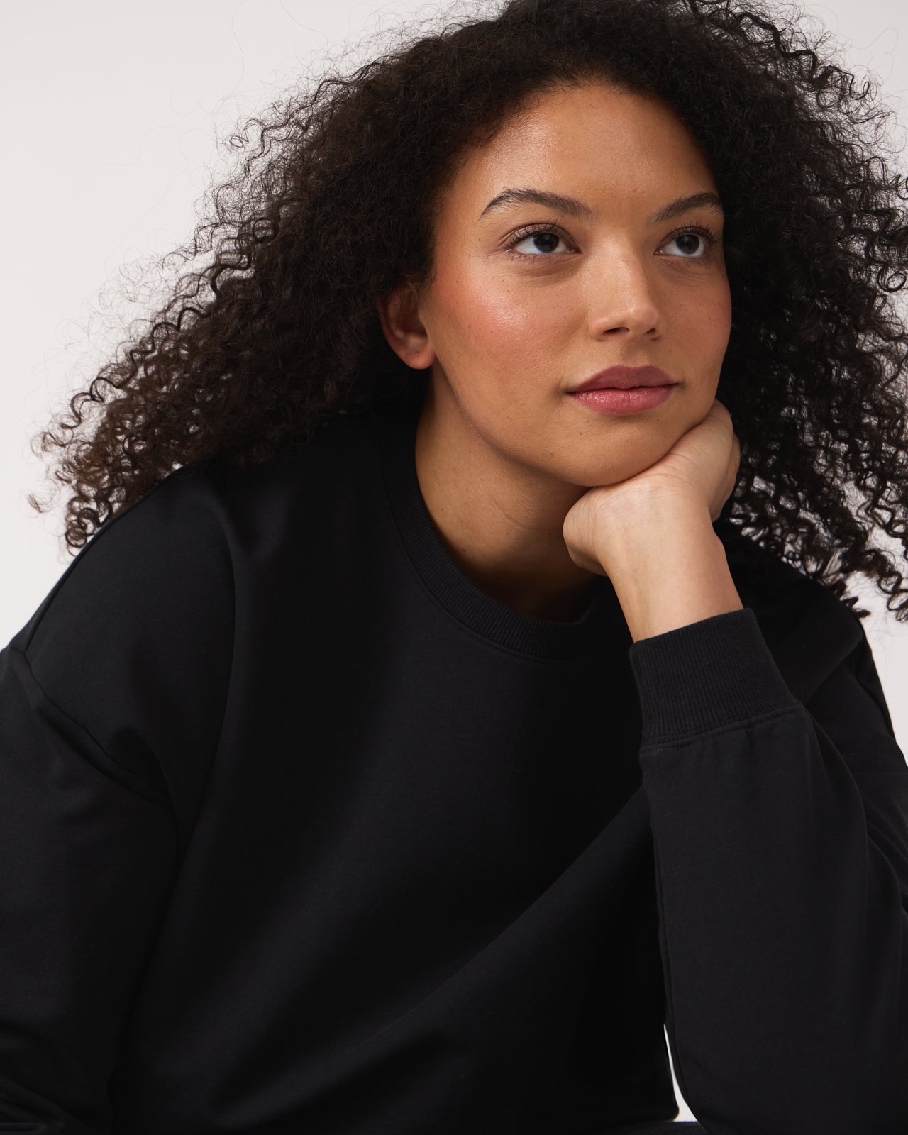 Close up of woman wearing the Black Women's Everyday Crewneck Sweatshirt