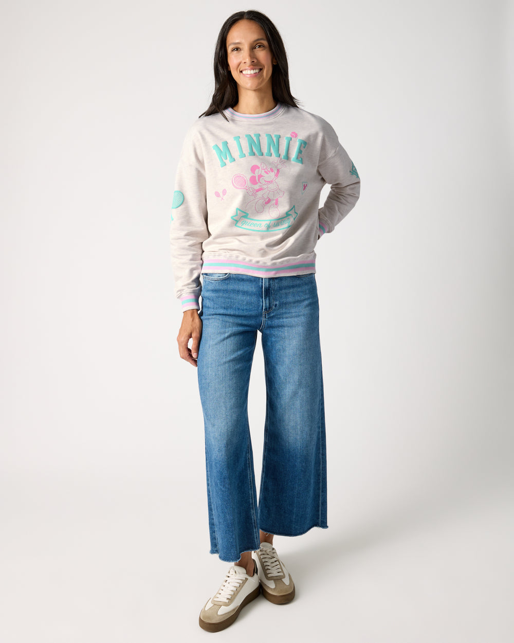 Woman wearing the Disney Minnie Mouse Queen of Swing Women's Crewneck Sweatshirt with jeans