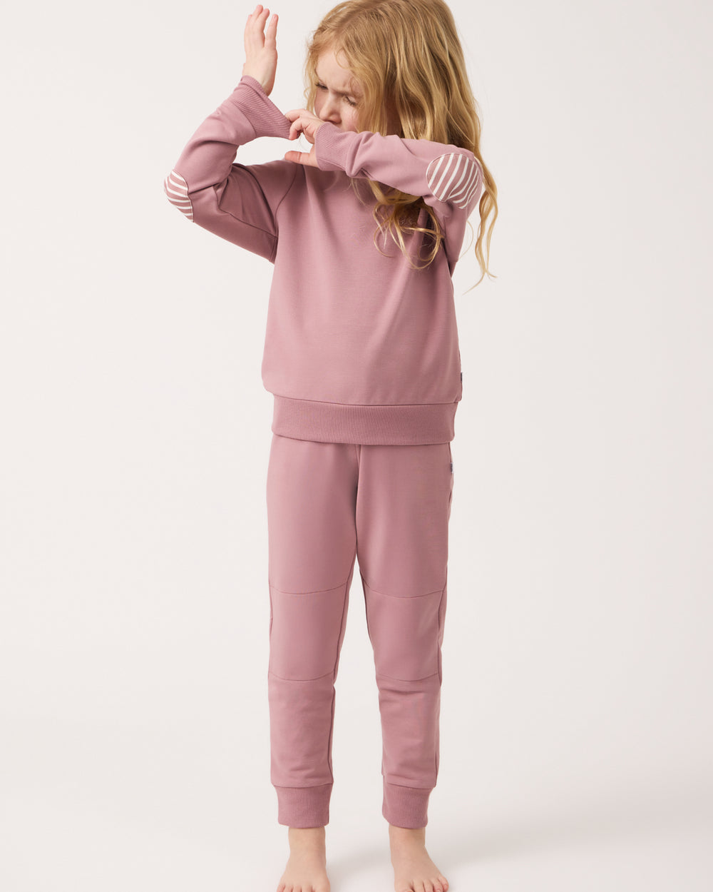 Child adjusting the cuff on the Rosewood Crewneck Sweatshirt