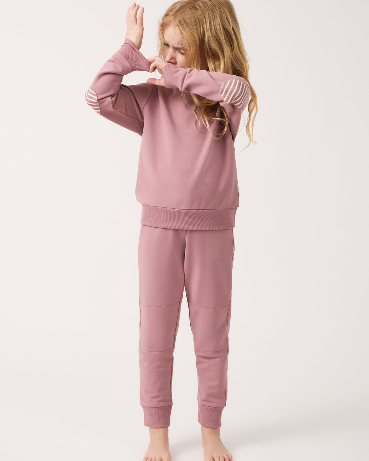Child adjusting the cuff on the Rosewood Crewneck Sweatshirt