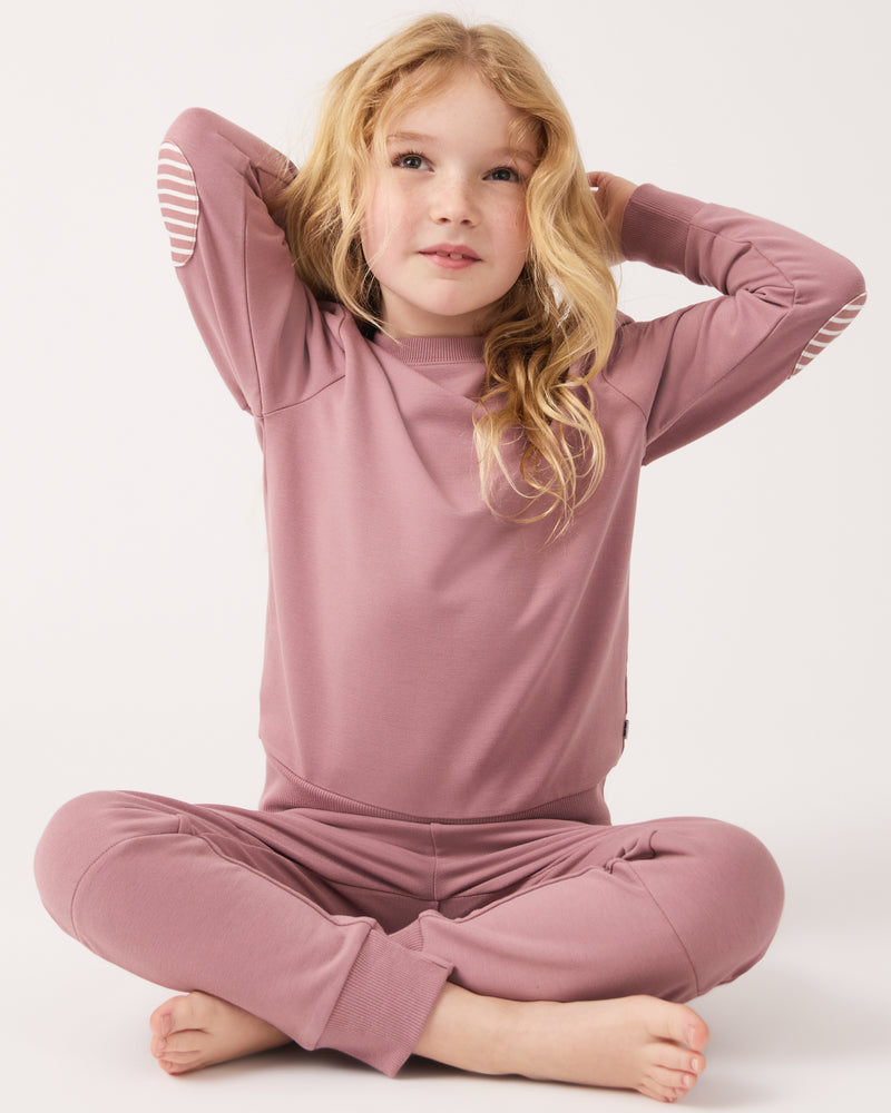 Sitting girl wearing the Rosewood Crewneck Sweatshirt and Sweatpants