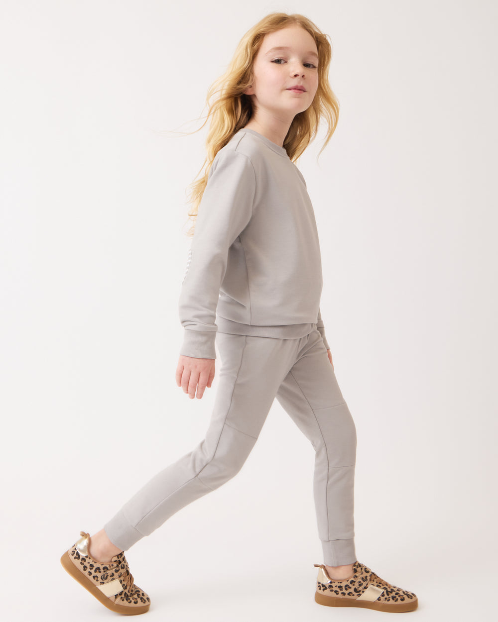 Walking girl wearing the Dove Gray Jogger with lifestyle sneakers