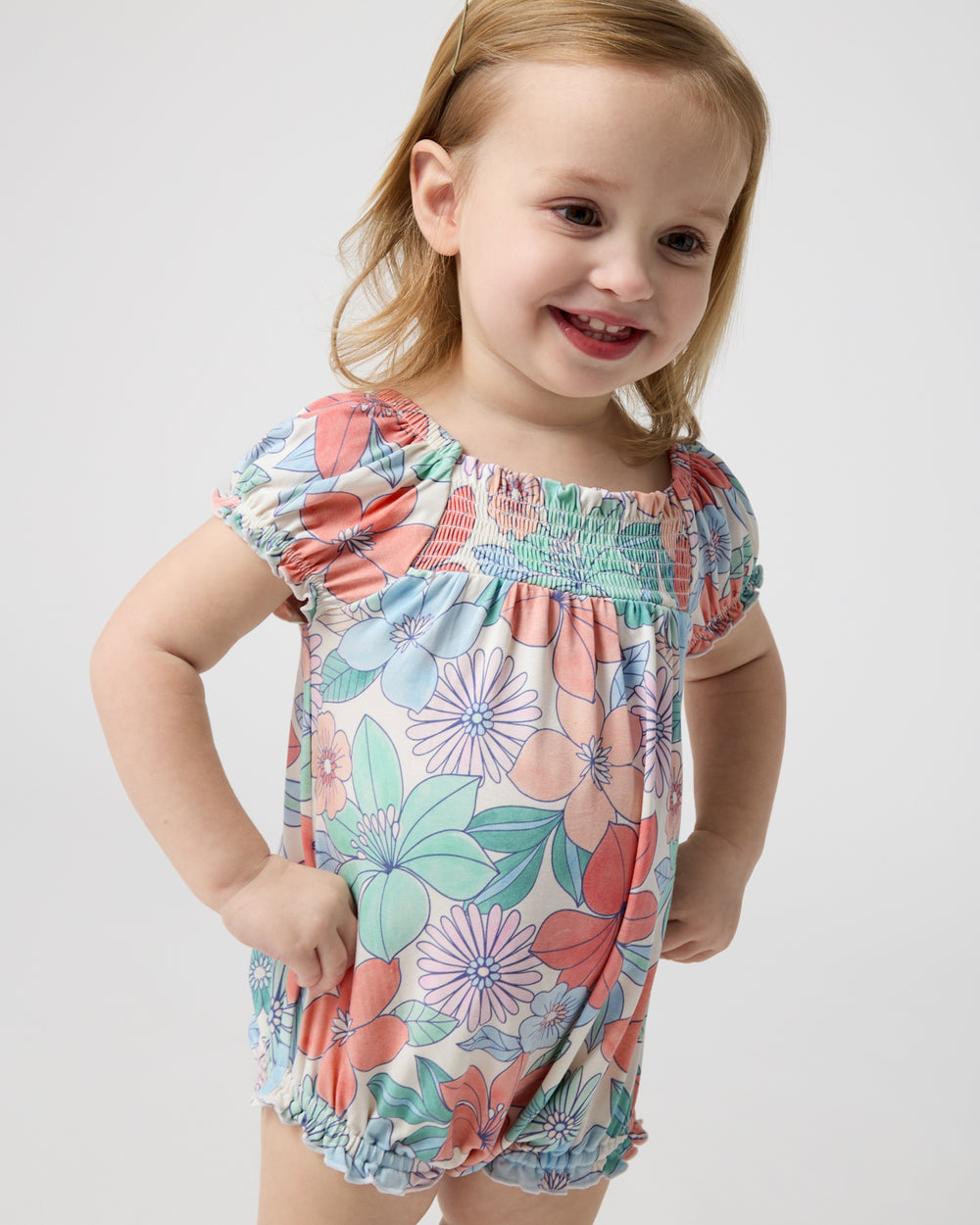 Toddler wearing the Shoreline Blooms Smocked Bubble Romper