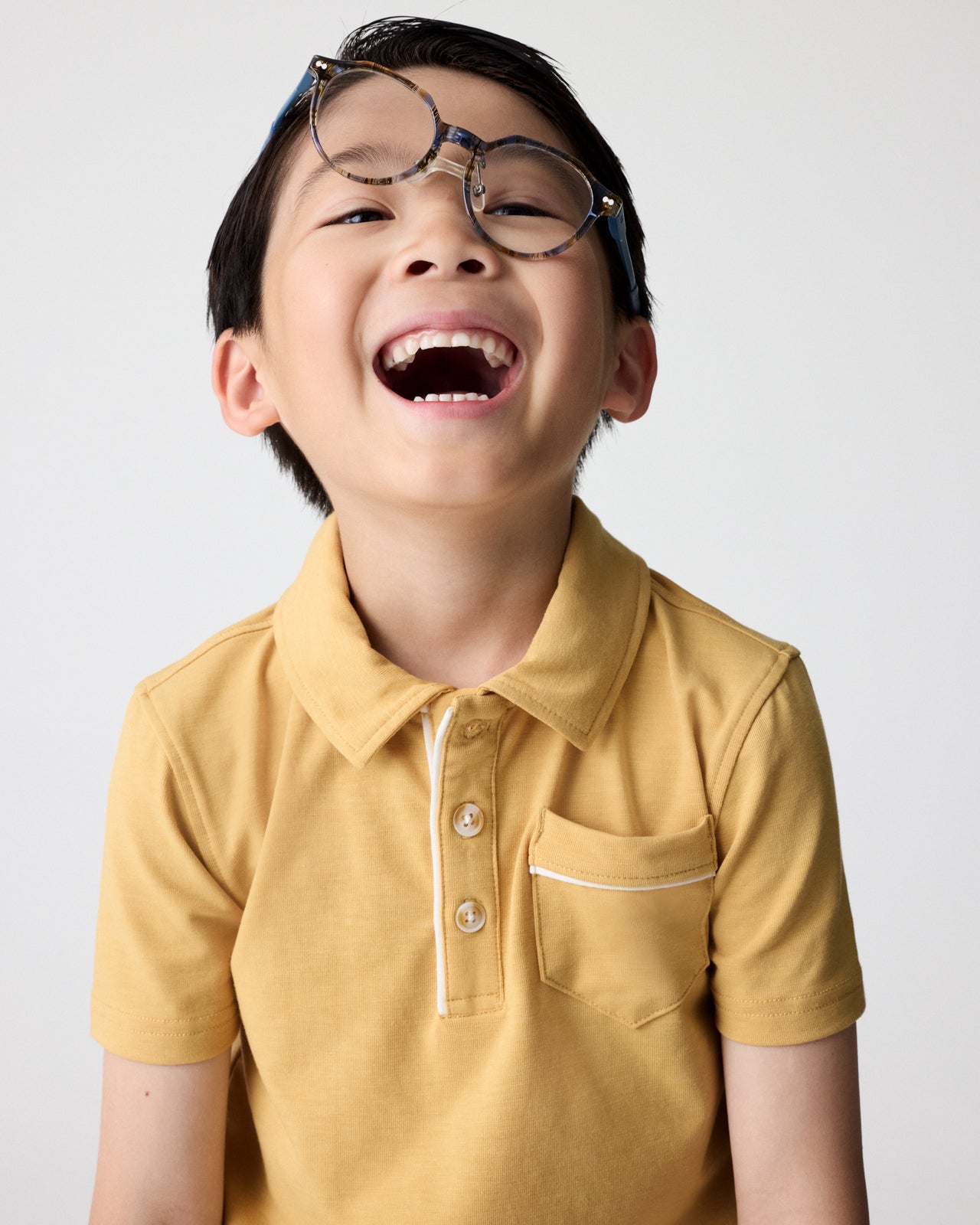 Close up of boy wearing the Honey Polo Shirt