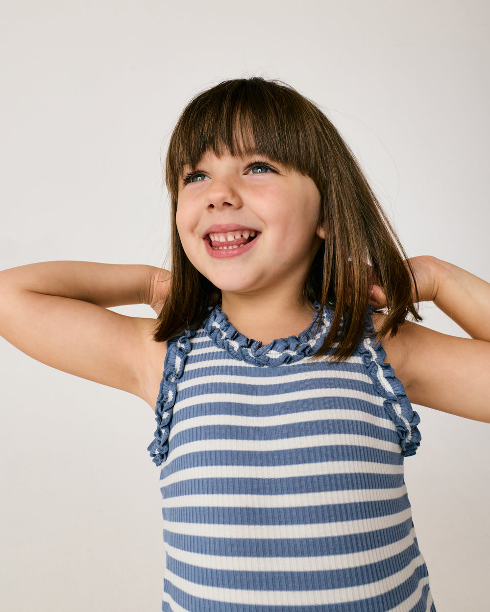 Close up of girl ewaring the Infinite Blue Stripe Ribbed Ruffle Tank