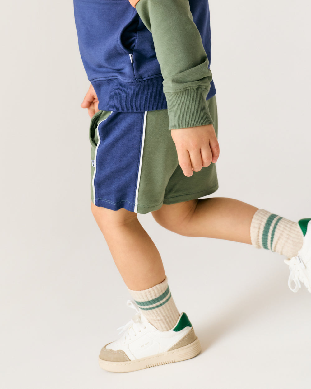 Close up of boy wearing the Moss Piped Short