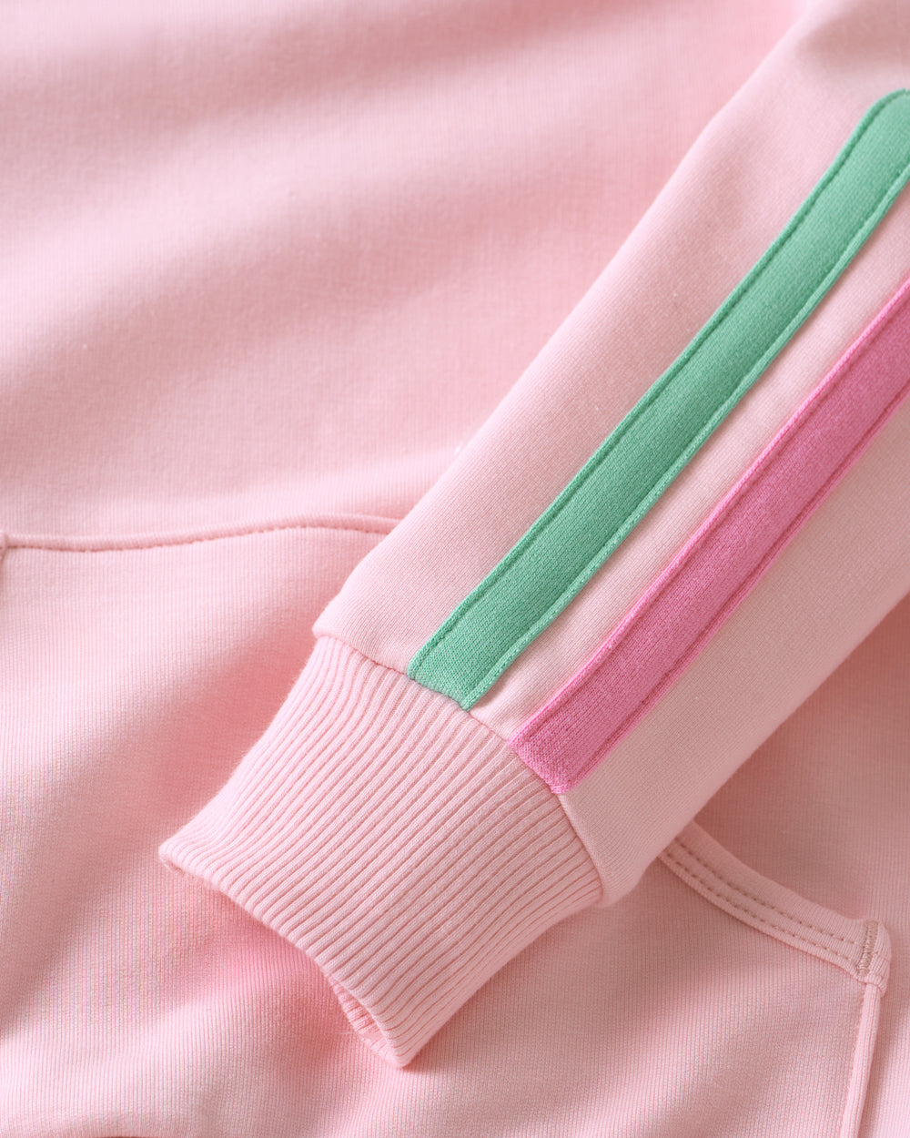 Close-up of a the green and pink stripes on the Pink Blossom Pocket Crewneck sleeves