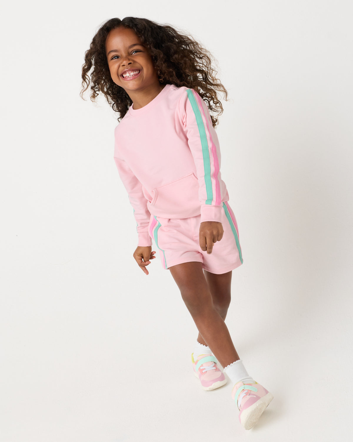 Girl wearing the Pink Blossom Pocket Crewneck and shorts