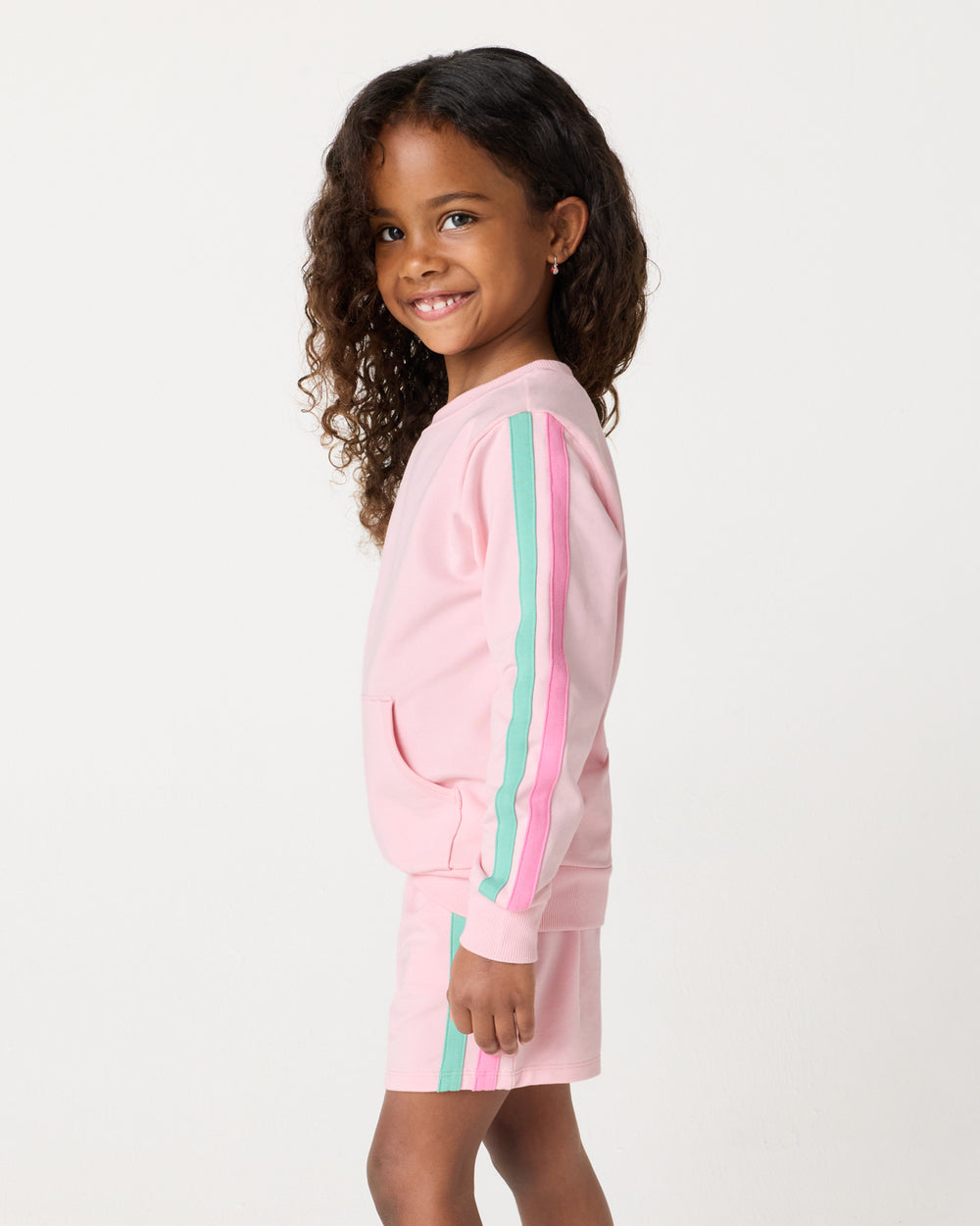 Side view of child wearing the Pink Blossom Pocket Crewneck