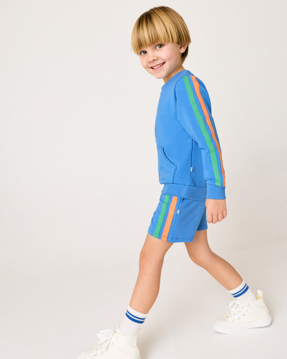 Walking boy wearing the Major Blue Pocket Crewneck with matching shorts
