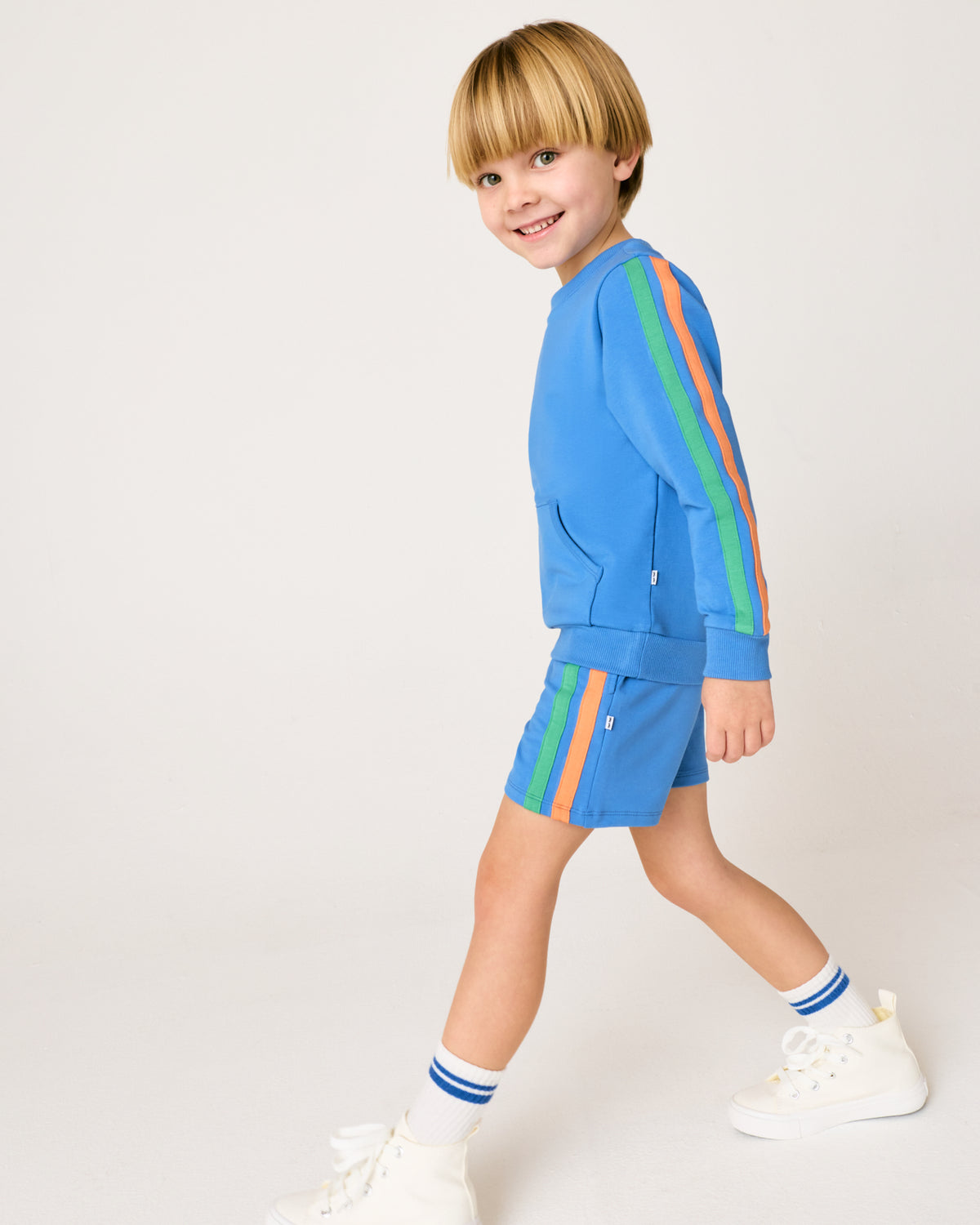 Walking boy wearing the Major Blue Pocket Crewneck with matching shorts
