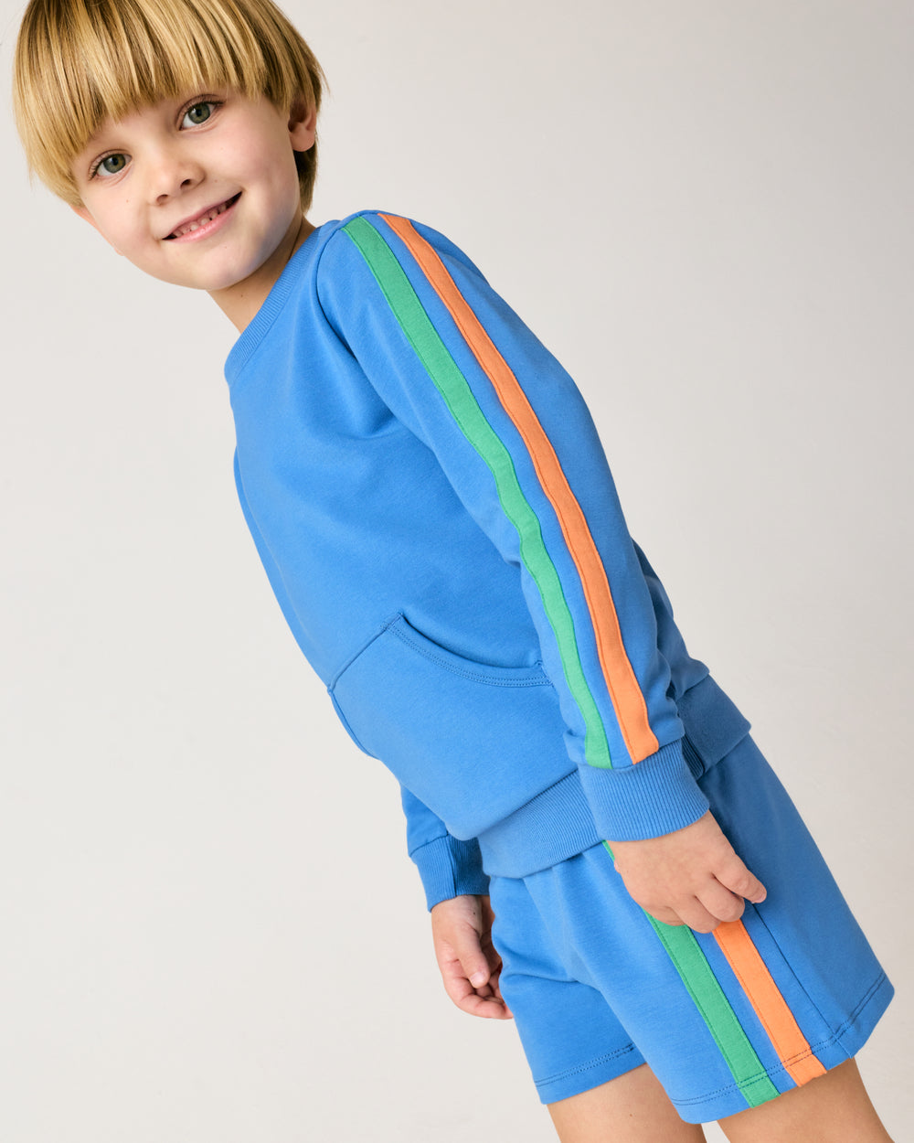 Close up of boy wearing the Major Blue Side Stripe Short and Crewneck