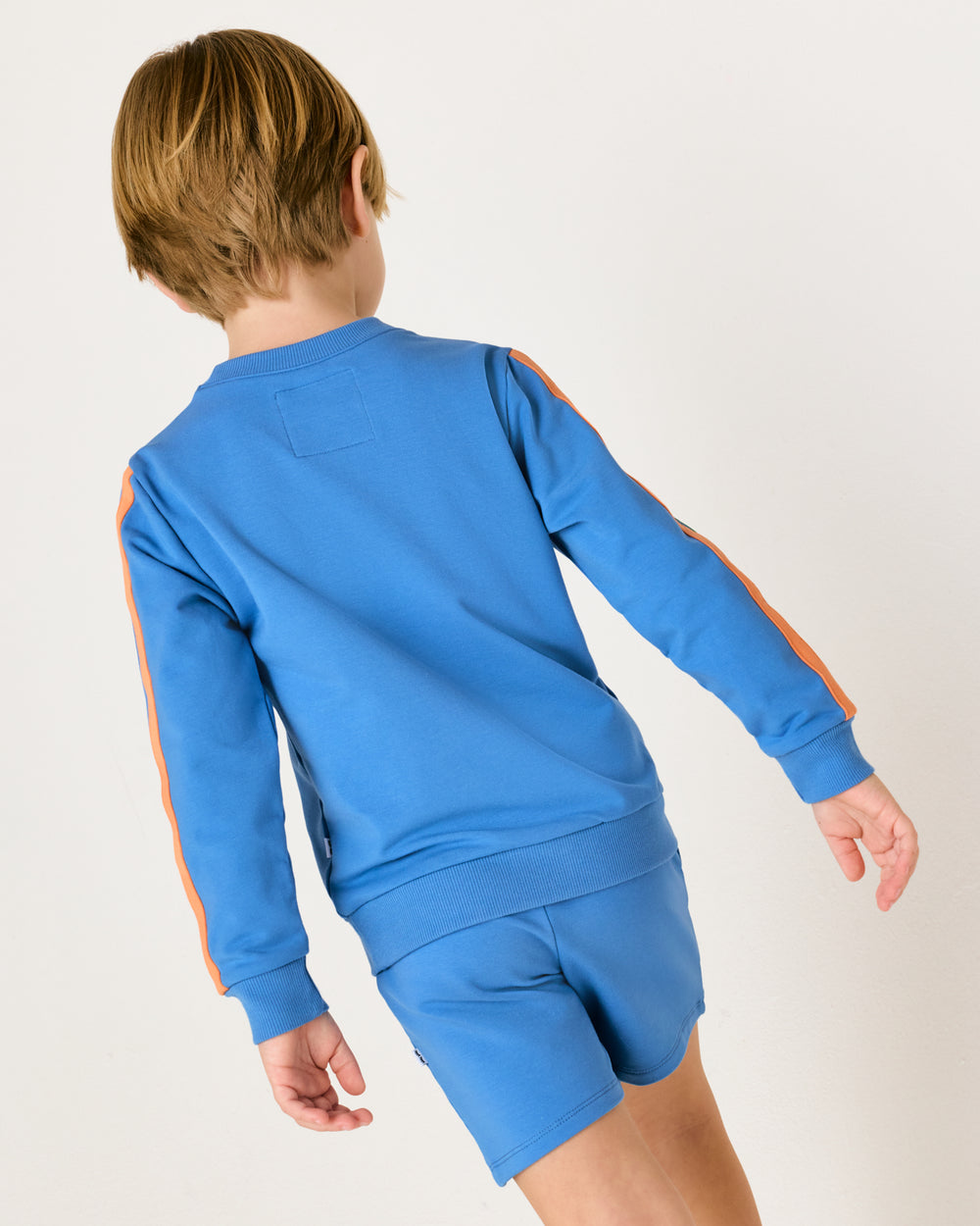 Back view of boy wearing the Major Blue Pocket Crewneck
