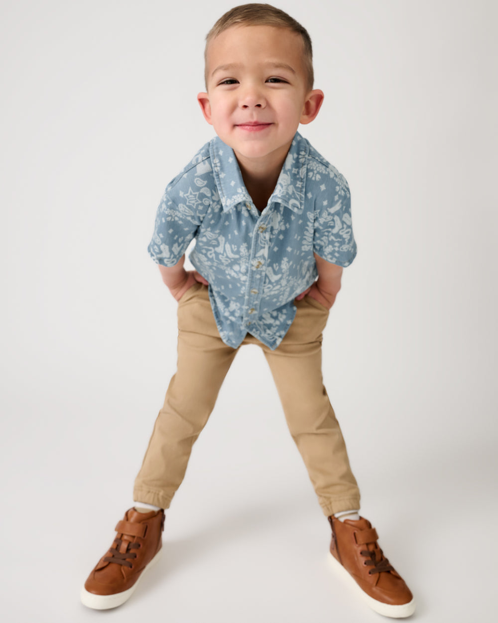 Boy wearing the Bandana Blues Denim Button Down Polo with khaki joggers