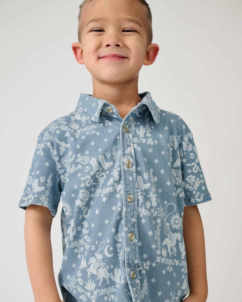Close up of boy wearing the Bandana Blues Denim Button Down Polo