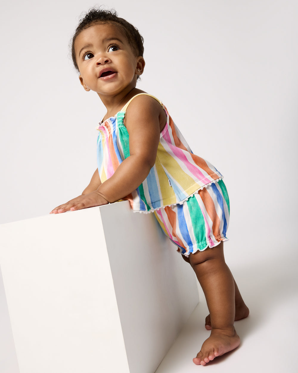 Baby wearing the Rainbow Ribbon Smocked Top with Bloomer Set