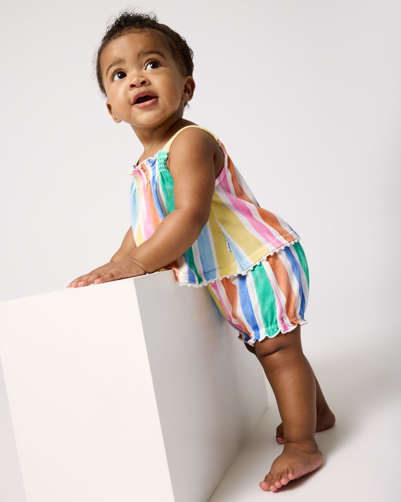 Baby wearing the Rainbow Ribbon Smocked Top with Bloomer Set
