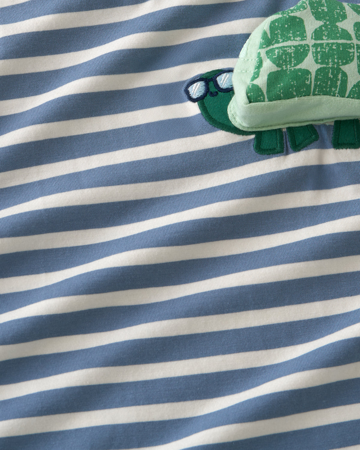 Close up of the striped fabric on the Zippy Turtle Relaxed Pocket Tee