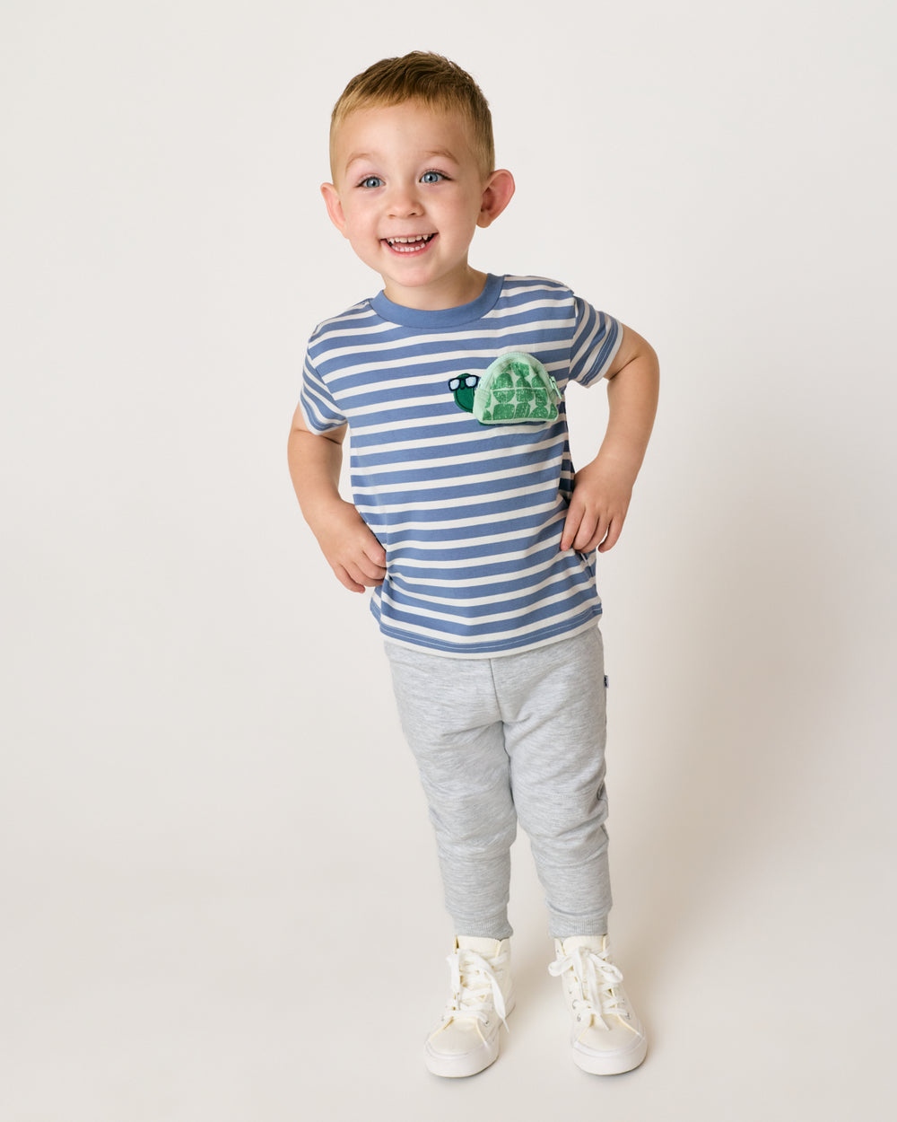 Boy wearing the Zippy Turtle Relaxed Pocket Tee with gray joggers