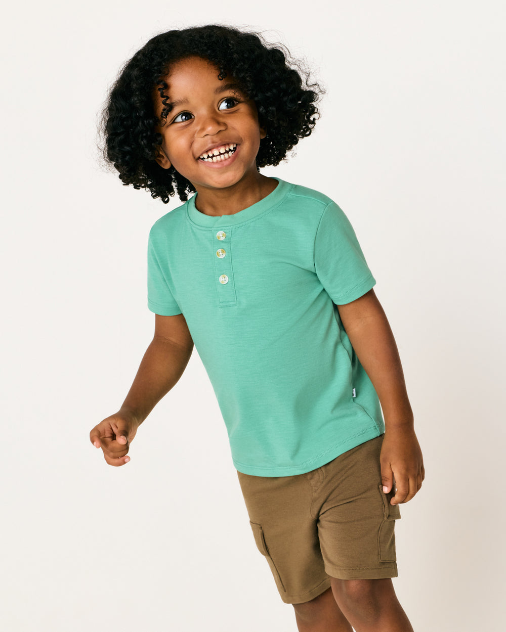 Boy wearing the Cool Jade Henley Tee with brown shorts