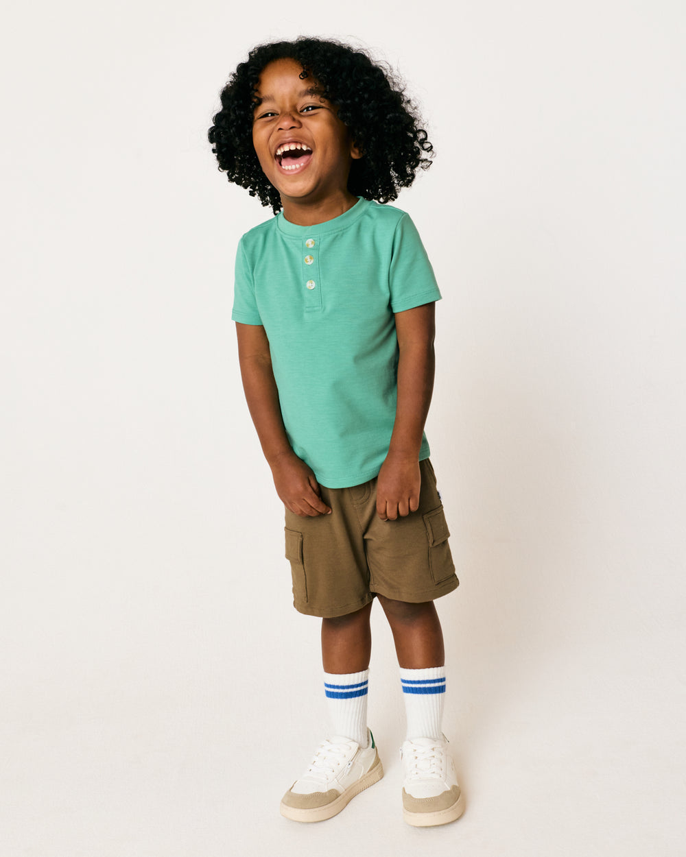 Standing boy wearing the Cool Jade Henley Tee with shorts
